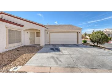 Charming single-story home with a well-maintained front yard, covered entryway, and two-car garage at 4828 Marco Polo St, North Las Vegas, NV 89031
