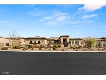 Charming single-story home with desert landscaping and a neatly maintained front yard at 5860 Noah Springs Ct, Las Vegas, NV 89149