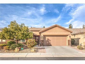 Charming single-story home with a well-maintained front yard, a two car garage and a desert landscaped yard at 6128 Forest Pony Ave, Las Vegas, NV 89122