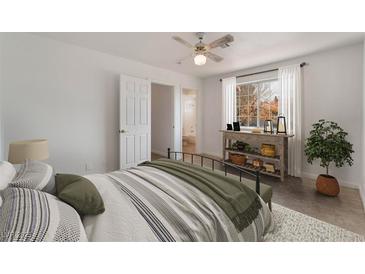 Bright bedroom featuring a ceiling fan, console table, and stylish bedding at 6808 Elm Creek Dr # 203, Las Vegas, NV 89108