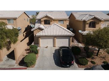 Charming home featuring a two-car garage, desert landscaping, and a neutral color scheme at 8008 Draco Cir # 201, Las Vegas, NV 89128