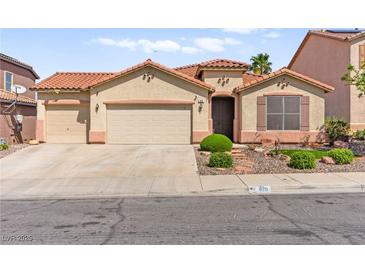 Charming single-story home with a tile roof, three-car garage, and desert landscaping at 820 Wintersweet Rd, Henderson, NV 89015