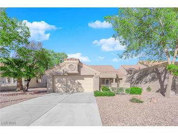 Charming single-story home featuring a well-manicured front yard and a two-car garage at 8620 Prairie Hill Dr, Las Vegas, NV 89134