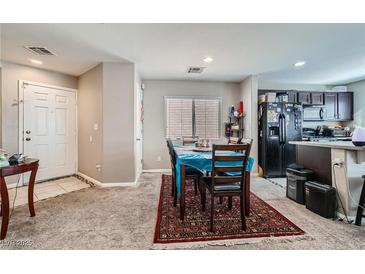 Welcoming dining area with a cozy rug, adjacent to the kitchen, offering an inviting space for Gathering meals at 9465 Milkweed Canyon Ave, Las Vegas, NV 89166