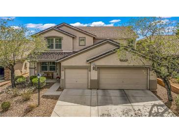 Charming two-story home featuring a two-car garage and well-maintained landscaping at 10385 Grassyrock Ct, Las Vegas, NV 89129
