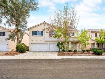 Charming two-story home boasts a well-manicured lawn, mature trees, and a spacious three-car garage at 1307 Bayleaf Terrace Ave, Henderson, NV 89014