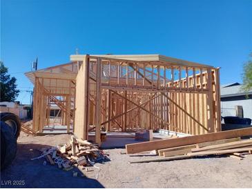 Image of new construction with the wooden frame under a clear blue sky at 1329 Price St, Henderson, NV 89011