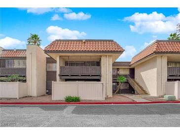 Inviting condo featuring a stucco exterior, balcony, and a red tile roof at 1440 Vegas Valley Dr # 14, Las Vegas, NV 89169