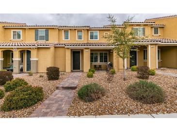 Inviting townhome featuring a cozy covered porch, low maintenance landscaping and a tiled roof at 2878 Starling Summit St, Henderson, NV 89044