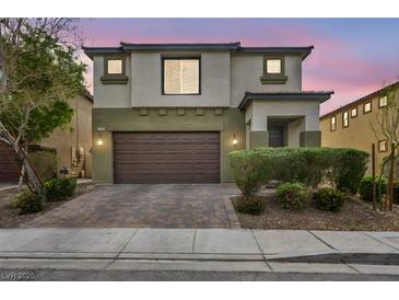 Two story home with a two car garage and landscaped yard, enhancing the property's curb appeal at 5232 Mountain Garland Ln, North Las Vegas, NV 89081