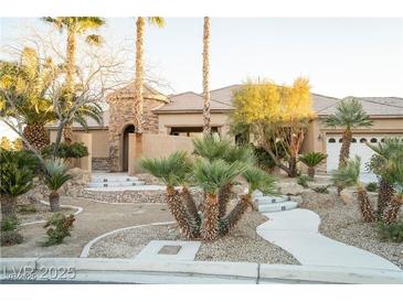 Landscaped front yard featuring a winding walkway, mature palm trees, and desert landscaping at 5527 Breecher Ave, Las Vegas, NV 89131