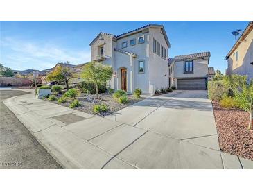 Two-story home boasts a landscaped front yard and a spacious driveway leading to a two-car garage at 5712 Almocita Ct, Las Vegas, NV 89141
