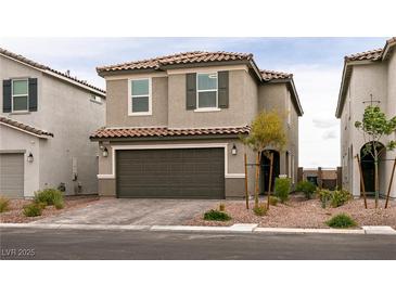 Charming two-story home featuring a tile roof, a two-car garage, and well-maintained landscaping at 9526 Granville Bridge St, Las Vegas, NV 89139