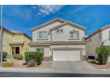 Inviting two-story home featuring a stucco facade, tile roof, and an attached two-car garage at 9732 Kampsville Ave, Las Vegas, NV 89148