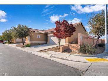 Single story home featuring a well-kept lawn, desert landscaping, and attached two car garage at 3792 Calle De Rio Ave, Las Vegas, NV 89115