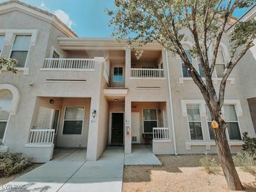 Inviting multi-story condo featuring a private balcony and well-maintained facade with nice front yard landscaping at 10001 Peace Way # 2269, Las Vegas, NV 89147