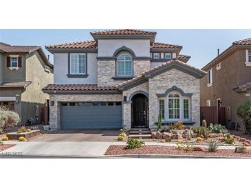 Charming two-story home featuring stone accents, a two-car garage, and desert landscaping in a well-maintained neighborhood at 1136 Jamesbury Rd, Las Vegas, NV 89135