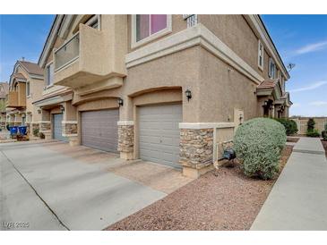 Charming townhome with attached garage, stone accents, and well-maintained landscaping at 1162 Red Margin Ct # 101, Las Vegas, NV 89183