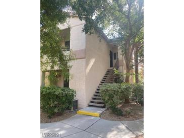 Inviting exterior featuring a two-story condo with steps leading to the entrance at 1830 Buffalo Dr # 2083, Las Vegas, NV 89128
