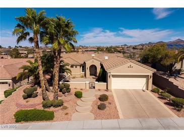 Charming single-story home with a well-manicured front yard, desert landscaping, and a two-car garage at 1908 Oliver Springs St, Henderson, NV 89052