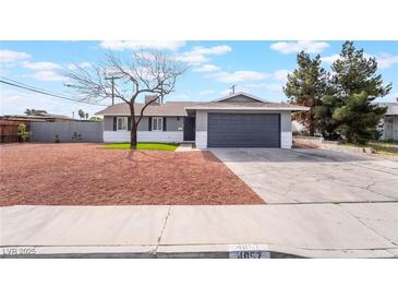Charming single-story home featuring gray paint, desert landscaping, and a two-car garage at 4857 Fairfax Ave, Las Vegas, NV 89120