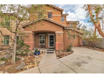Charming two-story home featuring a covered porch, desert landscaping and a tile roof at 5050 Secret Rock St, Las Vegas, NV 89122