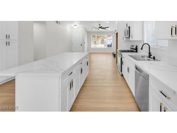Bright kitchen with white cabinets, stainless steel appliances, and a large island at 6248 Spanish Moss Ave, Las Vegas, NV 89108