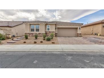 Charming single-story home with a two-car garage and manicured landscaping at 7525 Campbell Ranch Ave, Las Vegas, NV 89179