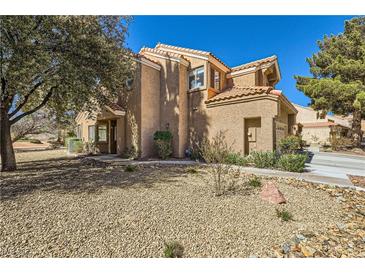 Charming two-story home with a classic stucco exterior and a well-maintained gravel front yard at 7636 Sudan Ct, Las Vegas, NV 89149
