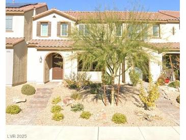 Charming home featuring a well-manicured, low-water landscape with a decorative stone walkway leading to the front door at 1010 Belton Lake Ave, North Las Vegas, NV 89086
