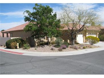 Charming single-story home featuring desert landscaping, a two-car garage, and a clay tile roof, perfect for low-maintenance living at 10112 Plomosa Pl, Las Vegas, NV 89134