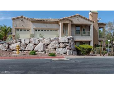 Charming two-story home with a rock-faced retaining wall and a two-car garage at 217 Big Horn Dr # 3, Boulder City, NV 89005