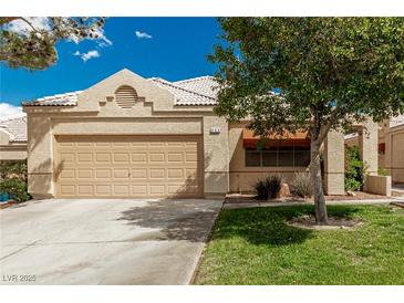 Charming single-story home featuring a well-maintained front yard and a two-car garage at 344 Mill Hollow Rd, Las Vegas, NV 89107