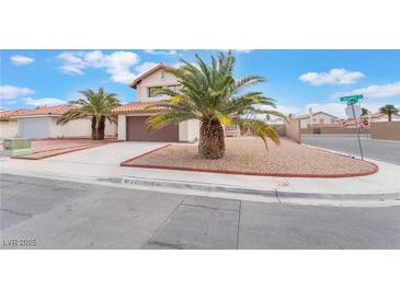 Charming two-story home with a lush palm tree, a driveway, and a terracotta-tiled roof at 4712 Belshire Dr, Las Vegas, NV 89147
