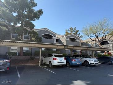 Exterior view of the condos with covered parking and a blue sky backdrop at 5055 W Hacienda Ave # 2175, Las Vegas, NV 89118