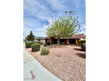 Charming single-story home with mature landscaping, decorative rock ground cover, and a large tree at 5268 Caspian Dr, Las Vegas, NV 89118