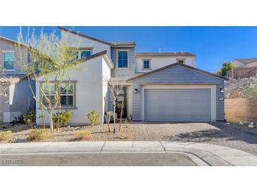 Charming two-story home with a well-maintained front yard and a two-car garage at 6 Lilla Rosa St, Henderson, NV 89011