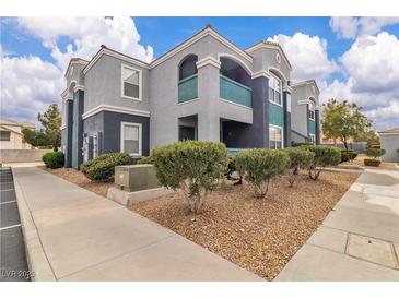 Stylish condo building featuring well-maintained landscaping and a neutral color palette exterior at 6955 N Durango Dr # 1074, Las Vegas, NV 89149