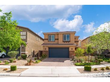 Two-story home featuring a brick-paved driveway and a dark garage door, complemented by desert landscaping at 7322 Dazzle Point St, North Las Vegas, NV 89084