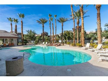Resort-style pool with palm trees and lounge chairs for relaxing on a sunny day at 8000 Badura Ave # 2063, Las Vegas, NV 89113