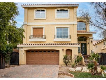 Charming two-story home with a two-car garage and beautifully landscaped front yard and brick driveway at 8467 Bismark Sapphire St, Las Vegas, NV 89139