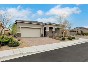 Charming single-story home with a two-car garage, desert landscaping, and inviting stone accents at 10161 Ocher Valley Ave, Las Vegas, NV 89178