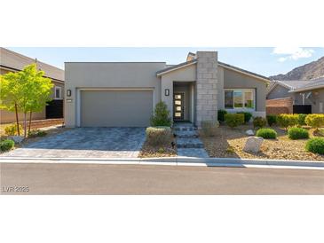 Charming single-story home featuring modern architectural details, desert landscaping, and a spacious two-car garage at 11161 Black Fire Opal Dr, Las Vegas, NV 89138