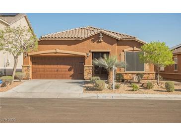Charming single-story home features a low-maintenance desert landscape, covered entrance, and a two-car garage at 132 Soaring Sky Ave, Henderson, NV 89011