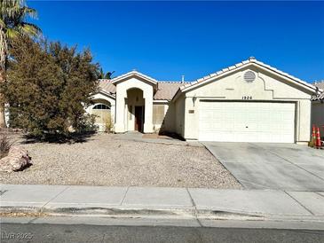 Charming single-story home with a well-maintained xeriscaped front yard and two-car garage at 1906 Double Delight Ave, North Las Vegas, NV 89032