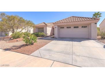 Charming single-story home with a well-maintained desert-style front yard and attached two-car garage at 2456 Desert Sands Dr, Las Vegas, NV 89134
