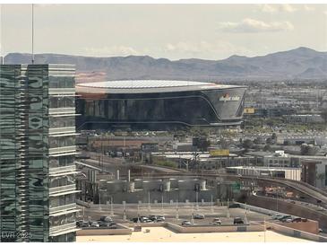 A view of the Allegiant Stadium and surrounding cityscape, with mountains in the background at 2600 W Harmon Ave # 25019, Las Vegas, NV 89158