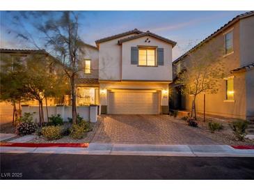 Charming two-story home with a two-car garage and brick-paved driveway, nicely landscaped at 27 Parco Fiore Ct, Henderson, NV 89011