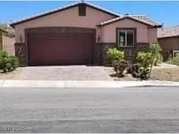 Charming single-story home with stone accents, a two-car garage, and low-maintenance landscaping at 2748 Brinkley Manor St, Laughlin, NV 89029