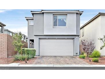 Modern two-story home featuring a neutral color scheme, well-maintained landscaping, and a spacious two-car garage at 4163 Peaceful Meadow St, Las Vegas, NV 89135